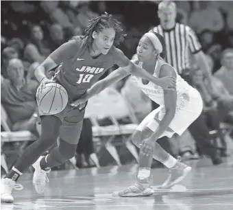  ?? THE ASSOCIATED PRESS ?? James Madison’s Aneah Young, with ball, is guarded by Tennessee’s Anastasia Hayes during Wednesday night’s game in Knoxville. The 13th-ranked Lady Vols won 89-60.