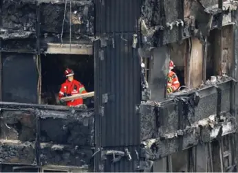  ?? TOLGA AKMEN/AFP/GETTY IMAGES ?? The fire at Grenfell Tower spread so quickly because of the building’s recently installed combustibl­e cladding.