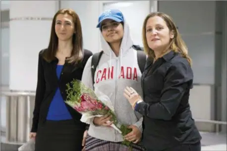  ?? CHRIS YOUNG — THE CANADIAN PRESS VIA AP ?? Rahaf Mohammed Alqunun, 18, center, stands with Canadian Minister of Foreign Affairs Chrystia Freeland, right, as she arrives at Toronto Pearson Internatio­nal Airport, on Saturday.