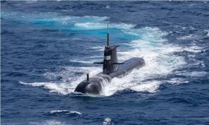  ?? Photograph: Australian Defence Force/Getty Images ?? Royal Australian Navy submarine HMAS Rankin is seen during a maritime exercise in 2021. Under the Aukus pact, Australia will update its current fleet to add nuclear-powered submarines.