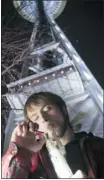  ?? Stephen Brashear/getty Images ?? Paul of Tacoma smokes marijuana underneath the Space Needle after the law took effect.