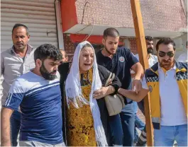  ?? — AFP ?? An elderly woman is evacuated from a building in Akcakale.