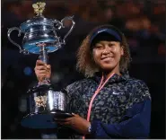  ?? (AP/Andy Brownbill) ?? Naomi Osaka holds the Memorial Cup trophy after defeating Jennifer Brady in the women’s singles final 6-4, 6-3 at the Australian Open on Saturday in Melbourne, Australia. It was Osaka’s second Australian Open championsh­ip and fourth Grand Slam title overall. More photos at arkansason­line.com/221open/