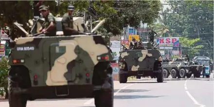  ?? REUTERS PIC ?? Soldiers patrolling a road in Hettipola, Sri Lanka, on Tuesday.