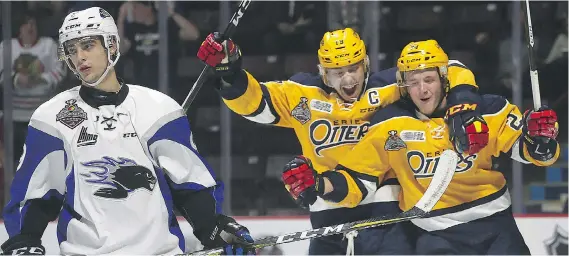  ?? DAN JANISSE ?? Saint John Sea Dogs’ defenceman Joe Veleno, left, skates away as the Erie Otters’ Dylan Strome, centre, and Darren Raddysh celebrate a goal during Friday’s semifinal game at the Memorial Cup in Windsor. The Otters won 6-3 to advance to Sunday’s final...