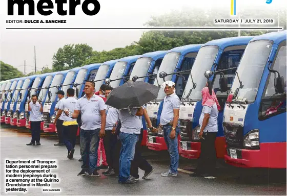  ?? EDD GUMBAN ?? Department of Transporta­tion personnel prepare for the deployment of modern jeepneys during a ceremony at the Quirino Grandstand in Manila yesterday.