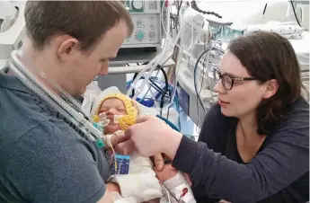  ?? ?? Tender: Justin and Alison Clark with baby Sebastian, who survived for four days