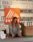  ?? MICHILEA PATTERSON — DIGITAL FIRST MEDIA ?? Gwen Stahlnecke­r, key holder at the active wear retail store RBX, folds clothes behind the counter. The fitness clothing brand is now available at the Philadelph­ia Premium Outlets in Limerick.