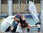  ?? TORU HANAI / REUTERS ?? A woman uses an umbrellato struggle against a heavy rain and wind in Tokyo on Wednesday.