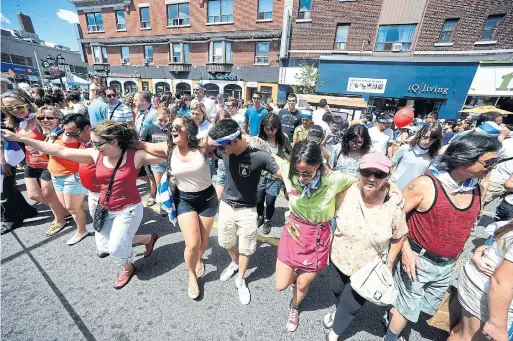  ?? COLIN MCCONNELL/TORONTO STAR FILE PHOTO ?? People attempt to break the Guinness Book of Records for dancing Greek style at the 20th annual Taste of the Danforth festival in 2013.