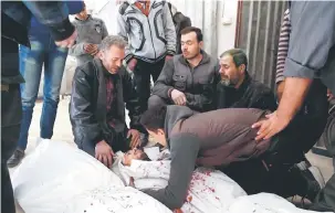  ?? — Gambar AFP ?? SUASANA PILU: Sekumpulan lelaki meratapi jenazah ahli keluarga di hospital di bandar Hamouria, di Ghouta Timur di pinggir Damsyik, ekoran serangan roket dan mortar kelmarin.