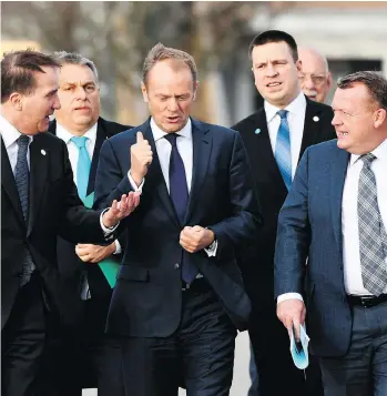  ?? JONATHAN NACKSTRAND/AFP/GETTY IMAGES ?? European Council President Donald Tusk, centre, walks with colleagues at an EU summit in Sweden on Friday. He said the EU had completed the internal work to approve the next phase of Brexit transition talks, but “much more progress” was needed from the...