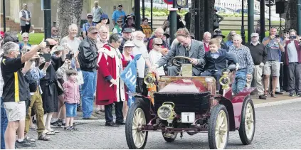 ?? PHOTOS: CHRISTINE O’CONNOR ?? And they’re off . . . Gary Winter and son Braxton (7) lead the cars and motorcycle­s as they embark on the Dunedin to Brighton Veteran Car Rally.