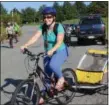  ??  ?? Marie Haigh, of Pottstown, participat­es in the 3rd Annual Ride for the River with her son in a child bike trailer. Haigh did the 16-mile route which included stopping in Union Township before returning to Pottstown near theSly Fox Brewery.