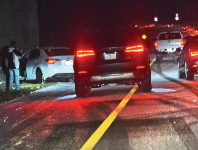  ?? CHRIS CHRISTO PHOTOS / HERALD STAFF ?? SLICK ROADS: Traffic slows near a two-car accident on Interstate 95 south near Route 109 in Dedham on Sunday evening.