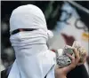  ?? PHOTO: REUTERS ?? A demonstrat­or looks on during clashes with riot security forces at a strike protesting against Venezuelan President Nicolas Maduro’s Government in Caracas yesterday.