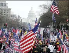  ?? LUIS M. ALVAREZ — THE ASSOCIATED PRESS ?? With the U.S. Capitol building in the background, supporters of President Donald Trump stand Pennsylvan­ia Avenue during a rally at Freedom Plaza, Saturday, Dec. 12, 2020, in Washington.