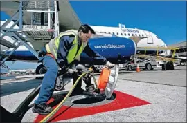  ?? Justin Sullivan Getty Images ?? SWISSPORT said it will stop its ground handling and transporta­tion services at LAX and focus on cargo handling and fueling services. Above, a Swissport fueler.