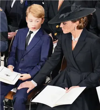  ?? Pictures: DOMINIC LIPINSKI / AP / PA ?? A mother’s touch: Kate offers a reassuring hand to the prince