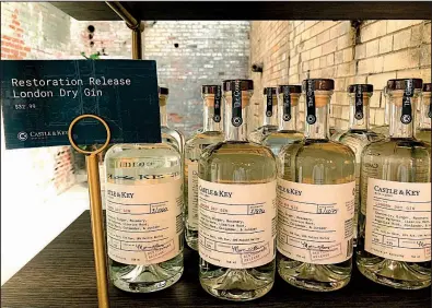  ?? AP/BRUCE SCHREINER ?? Bottles of gin produced at Castle &amp; Key Distillery in Millville, Ky., are displayed last week at the distillery’s gift shop. The revived distillery’s new bourbon won’t reach consumers until around 2021.