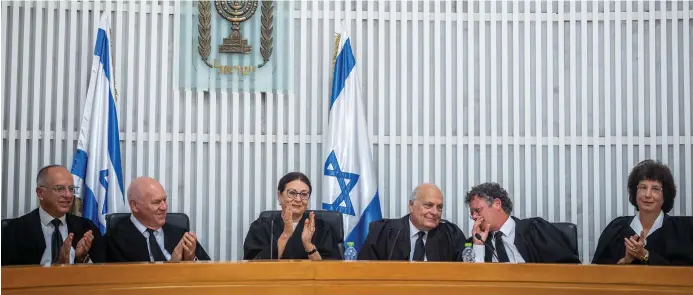  ?? (Yonatan Sindel/Flash90)3 ?? FORMER SUPREME Court chief justice Esther Hayut (C) with former Supreme Court judge George Karra (to her L) and Supreme Court justices at an outgoing ceremony held for Karra, at the Supreme Court in Jerusalem, 2022.