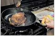  ??  ?? The steak cooks low and slow, at 225 degrees, in the oven until the middle reaches 110 degrees. Then it's browned in a hot skillet, while being basted with butter to help promote the browning.