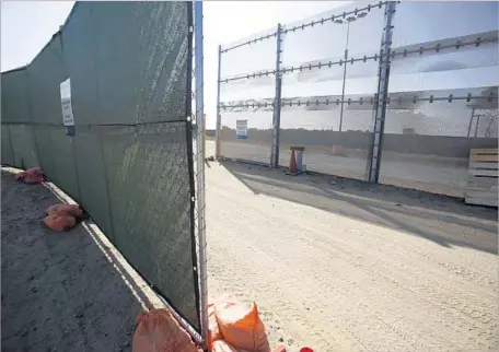  ?? Alejandro Tamayo San Diego Union-Tribune ?? CHAIN-LINK fencing was installed at the Otay Mesa site where competing companies will build models of their proposals for President Trump’s border wall. The San Diego County Sheriff ’s Department said it is evaluating the need for a “free speech” area...