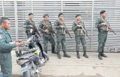  ??  ?? CRIMINAL CALL CENTRE: Cambodia police at a condo where they arrested Chinese men and women carrying out telephone and internet scams on victims in China.