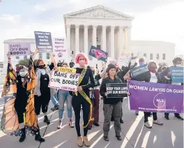  ?? DREW ANGERER/GETTY ?? Abortion rights and anti-abortion activists demonstrat­e Nov. 1 outside the Supreme Court as the justices hear arguments in a challenge to an abortion law.