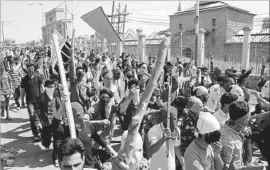  ?? Mukhtar Khan Associated Press ?? PROTESTERS march in Srinagar, in the Indian-held portion of Kashmir. Clashes with security forces across the Himalayan territory left dozens injured.