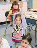  ?? ?? First-grader Piper Ostruzka raises her hand during class at Cos Cob School.