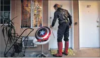  ?? AP PHOTO ?? Captain America impersonat­or Henry Hodge, a cinematogr­apher from England who lives a stone’s throw away from Hollywood’s Dolby Theatre, opens his apartment door in Los Angeles.