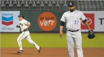  ?? Jeff Chiu / Associated Press ?? Alex Dickerson runs the bases after hitting a solo home run off Colorado’s Jairo Diaz in the seventh inning. The Giants added two more runs in the inning.