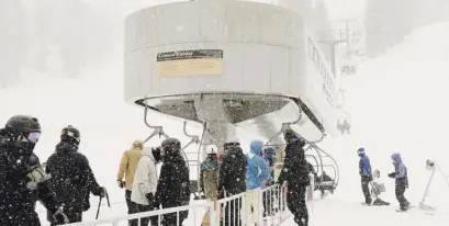  ?? Ap ?? SURPRISE! Skiers line up at the Caynon Express high speed chairlift in Mammoth Mountain in Mammoth Lakes, Calif., on Friday.