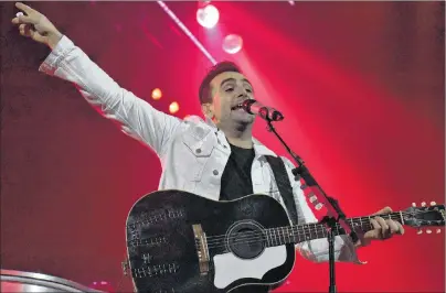  ?? DESIREE ANSTEY/ JOURNAL PIONEER ?? Lead singer of the rock band Hedley, Jacob Hoggard, strums his guitar on Summerside’s stage.