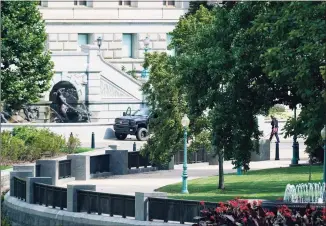  ?? Alex Brandon / Associated Press ?? Authoritie­s investigat­e a pickup truck parked on the sidewalk in front of the Library of Congress’ Thomas Jefferson Building, as seen from a window of the Capitol on Thursday in Washington.
