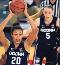  ?? Kathy Willens / Associated Press ?? UConn’s Olivia Nelson-Ododa (20) looks to pass as Paige Bueckers (5) looks on during a win at St. John’s on Feb. 17.