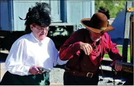  ??  ?? COLLIE, KNOWN AS “CHEROKEE KATE,” takes in Gale Hall during a re-enactment in the Gathering of the Gunfighter­s.