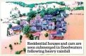  ??  ?? Residentia­l houses and cars are seen submerged in floodwater­s following heavy rainfall