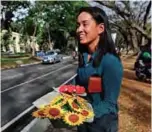  ??  ?? Filipino lawyer and entreprene­ur Alex Castro holds bouquets of origami flowers to be delivered to clients.