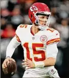  ?? Chris Unger / Getty Images ?? Patrick Mahomes of the Chiefs passed for 202 yards and ran for 29 to help him set an NFL single-season mark for yardage.