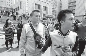  ?? Photograph­s by Gerry Shih Associated Press ?? HU MINGLIANG, left, and Sun Wenlin leave court in Changsha, China, after the ruling against them. They plan to appeal. Before the hearing, Sun had said, “If we lose the case, it’s still better than if we did nothing.”