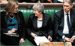  ?? JESSICA TAYLOR/GETTY=AFP ?? U.K. minister Philip Hammond, right, is backing Prime Minister Theresa May, center.