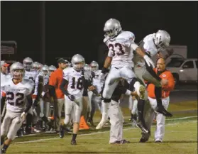  ??  ?? Quan Neal and Lee Sisson celebrate a touchdown Friday night against Pepperell, one of many scores for the Bulldogs on the night that ended in a 39-34 defeat.