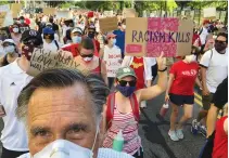  ?? (Reuters) ?? US SENATOR MITT ROMNEY marches during a protest against racial inequality in Washington DC on Sunday.