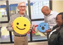  ?? MIKE DE SISTI /MILWAUKEE JOURNAL SENTINEL ?? Gov.-elect Tony Evers jokingly holds a smiley emoji pillow to reflect how he's feeling after winning the election.