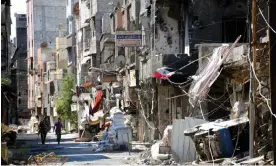  ?? The Asahi Shimbun/Getty Images ?? Soldiers walk through the Tadamon district of Damascus in September 2013. Photograph: