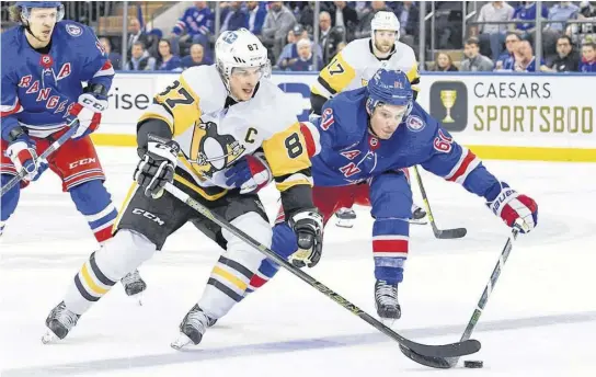  ?? DENNIS SCHNEIDLER-USA TODAY SPORTS ?? Pittsburgh Penguins centre Sidney Crosby (87) battles with New York Rangers defenceman Justin Braun (61) during an NHL playoff game at Madison Square Garden.