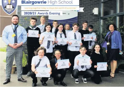  ??  ?? S2 prize-winners Acting depute head Sean O’Hara, left, and Mrs Leslie with back, from left, Andrew Craig, Jakub Aleksander, Grzegorz Lawniczak, Morven Moyes, Fraser Maccuish, Lewis Owen and Callum Fyfe; middle Eva Wilson, Kody Warner and Ruby Bell and front Ramsay Gregor-Jenney, Ailsa Kerr, Nikodem Grygar and Hope Woodcock