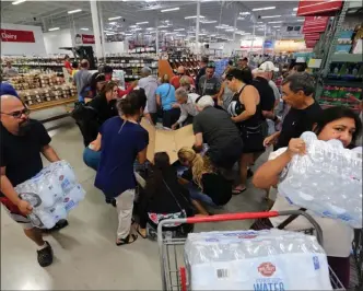 ?? The Associated Press ?? Residents purchase water on Tuesday at a wholesale warehouse in Miami in preparatio­n for Hurricane Irma, a category 5 storm that appears headed for the United States.